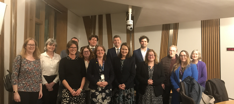 Alex stands with members of the Neurological Alliance of Scotland, MEAction Scotland, Cerebral Palsy Scotland, Epilepsy Scotland, Alzheimer Scotland, Parkinson's UK in Scotland, Headway Dundee & Angus, and Headway East Lothian.